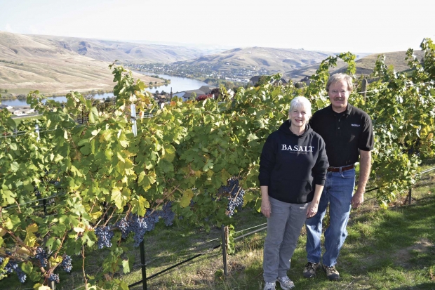 Lynn DeVleming and Rick Wasem are co-owners in Basalt Cellars, a Clarkston, Washington winery. They are standing in Wasem's vineyard that overlooks the Snake River.
