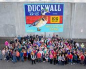 Duckwall Fruit current company staff stands outside their facility in Odell, Oregon, and a new mural celebrating the company’s 100 years of business in the Hood River Valley. (Courtesy Blaine Franger for Duckwall Fruit)