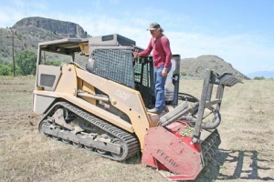 This was the first time Bob Brewer tried using the skid steer machine in a former orchard. 