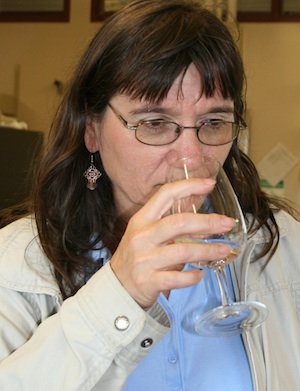 Carol Miles, head of the hard cider program at WSU in Mount Vernon, assesses the mouth feel of a hard cider. 