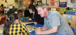 Royal City School District Superintendent Rose Search and Cliff Plath of Washington Fruit and Produce Company visit the Growing Great Learners preschool during a reading session. Photo courtesy of Educational Service District 105 
