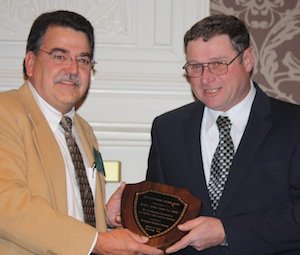 Dwight Mickey (right) receives the Pennsylvania Grower of the Year Award from Phil Baugher. 