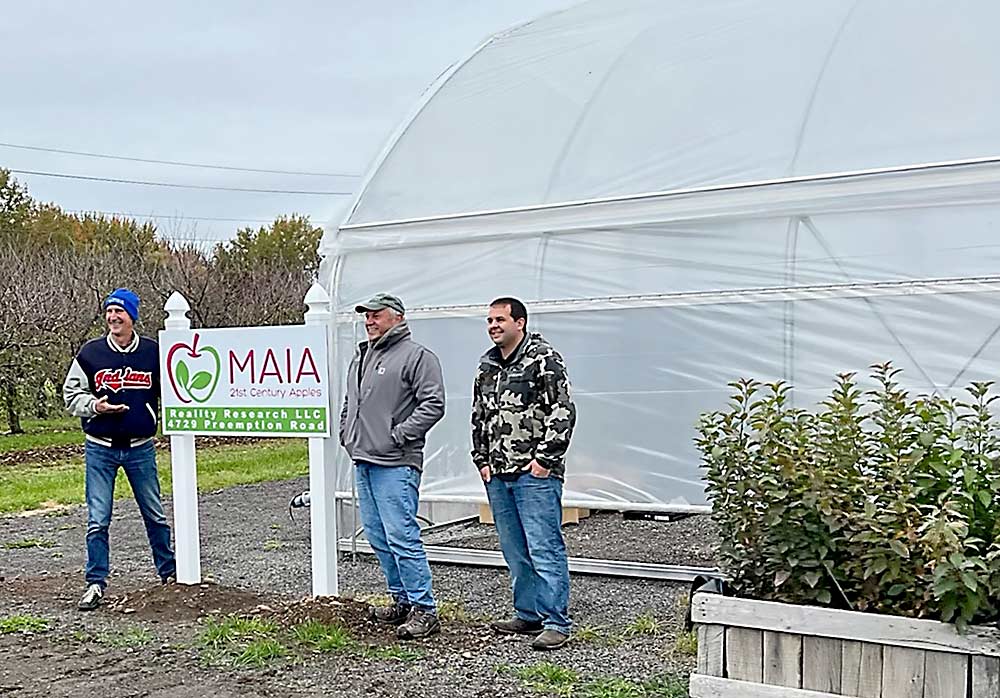 From left, Midwest Apple Improvement Association president Bill Dodd, horticultural consultant Bill Pitts and Reality Research co-owner Brad Palmer stand in front of the new greenhouse built by MAIA and Reality Research in Lyons, New York. The greenhouse will house most of MAIA’s apple-breeding activities. (Courtesy Reality Research)