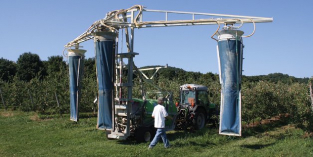 This sleeve sprayer was custom-built for Fruiteraie des Gadbois based on research findings by agricultural engineer Bernard Panneton. Fans on top push air down through the sleeves, pushing spray dispensed from nozzles mounted outside the sleeves.  (Richard Lehnert/Good Fruit Grower) 