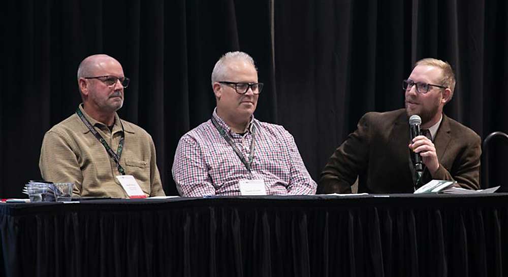 At right, Jacob Klaus, orchard manager for Gilbert Orchards, discusses how managing costs on a block basis is his first step toward profitable farming, on a panel with Keith Oliver of Olsen Bros., left, and Shawn Tweedy of Chiawana Orchards, center. (TJ Mullinax/Good Fruit Grower)