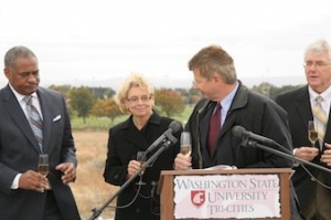 Ted Baseler, center, is joined in raising a toast to the new Wine Science Center with WSU President Elson Floyd, left, Governor Christine Gregoire, and David Porter of the U.S. Department of Commerce, right.