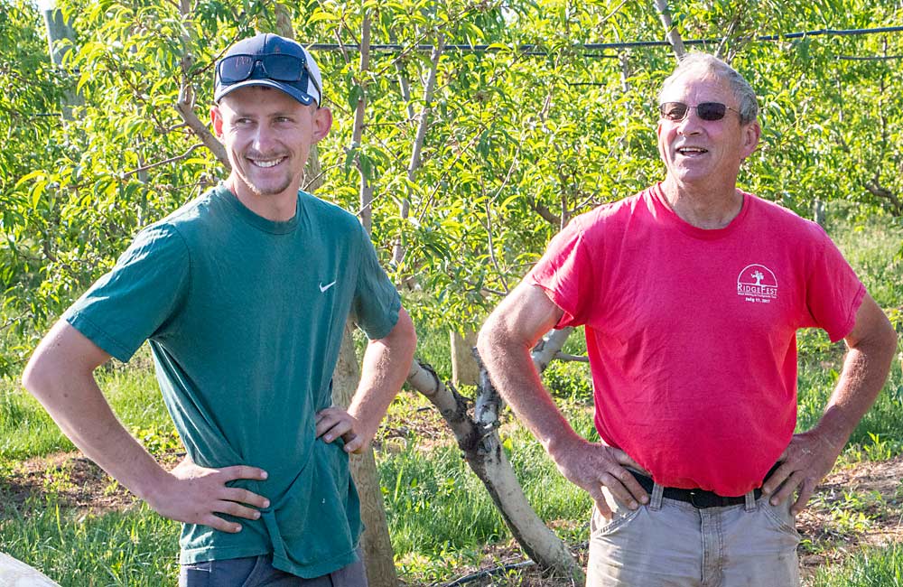 Kyle Rasch, left, and his father, Chuck Rasch, run Windy Ridge Orchards in Conklin, Michigan. They hope Accede chemical thinner will save time and money on hand thinning of peaches. (Matt Milkovich/Good Fruit Grower)