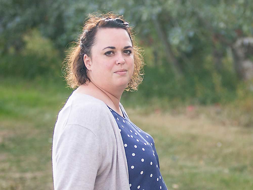 Sarah Rasmussen, safety manager for Gilbert Orchards in Yakima, Washington, poses for a photo in late September. Partly motivated by mental health concerns, Rasmussen lobbied for a Washington state rural health care access law that mandates insurance companies cover telehealth phone calls at the same rate as video conference visits. (Ross Courtney/Good Fruit Grower)