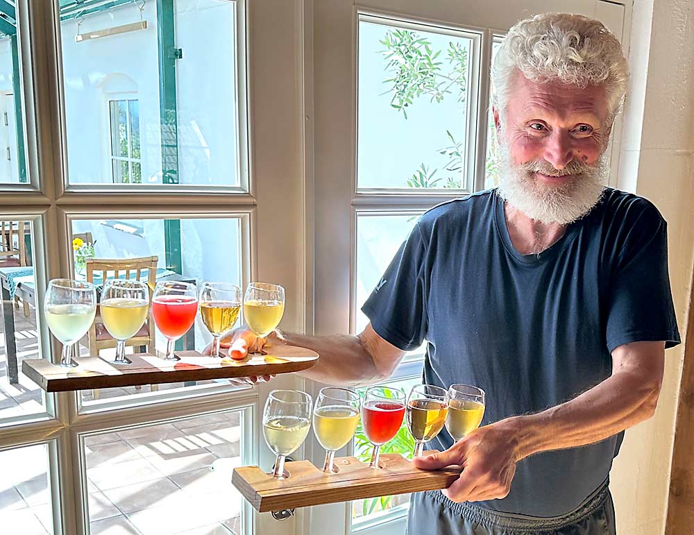 Åge Eitungjerde, owner of Ciderhuset cider in Balestrand, Norway, displays a variety of his craft ciders.  The region's climate encourages the apples to develop ideal acids to balance the sweetness of the cider.  (Susan Poizner/by Good Fruit Grower)