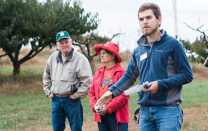 Michigan State University Extension tree fruit educator David Jones, right, leads a grower class in 2017. After fire blight became an issue in many Michigan apple orchards in 2018, Jones and a statewide team began searching for the cause of the outbreak. Jones focused on West Central Michigan and whether streptomycin resistance may have played a role. (Courtesy David Jones/MSU Extension)