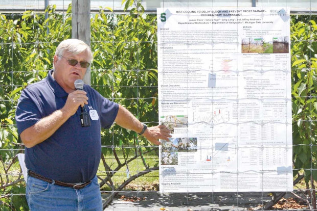Dr. James Flore explains how calcium chloride sprays can reduce sweet cherry cracking during rainy weather at a field day at the Clarksville Research Station on June 10, 2014. (Richard Lehnert/Good Fruit Grower)