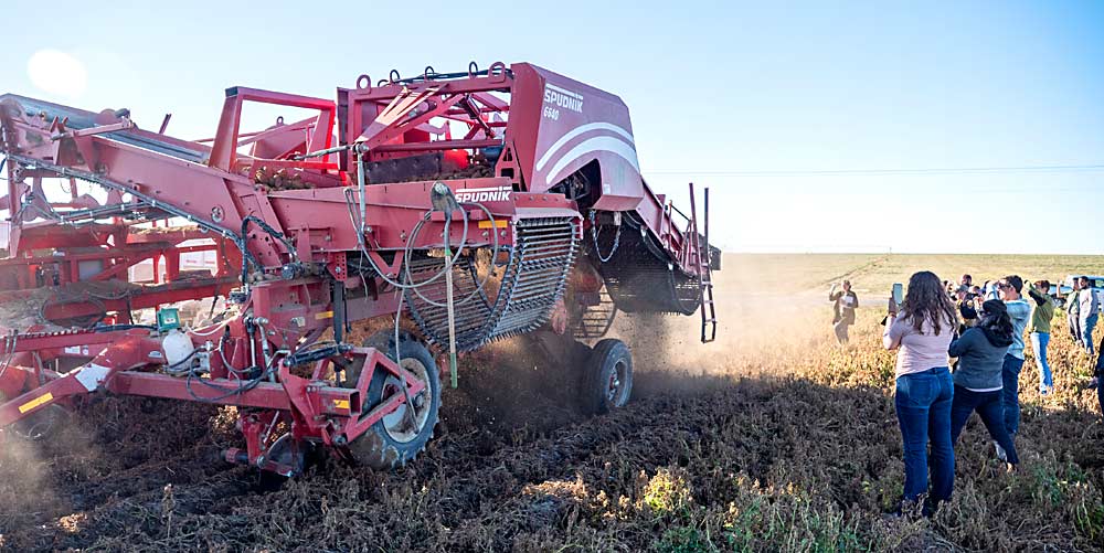 AgForestry Class 42 watches potato harvest at Friehe Farms in Moses Lake, Washington, in September.  Each class typically travels to 13 seminars during its term, with 11 in Washington state, one in Washington, DC, and one at an international destination.  (Courtesy Craig Walter)