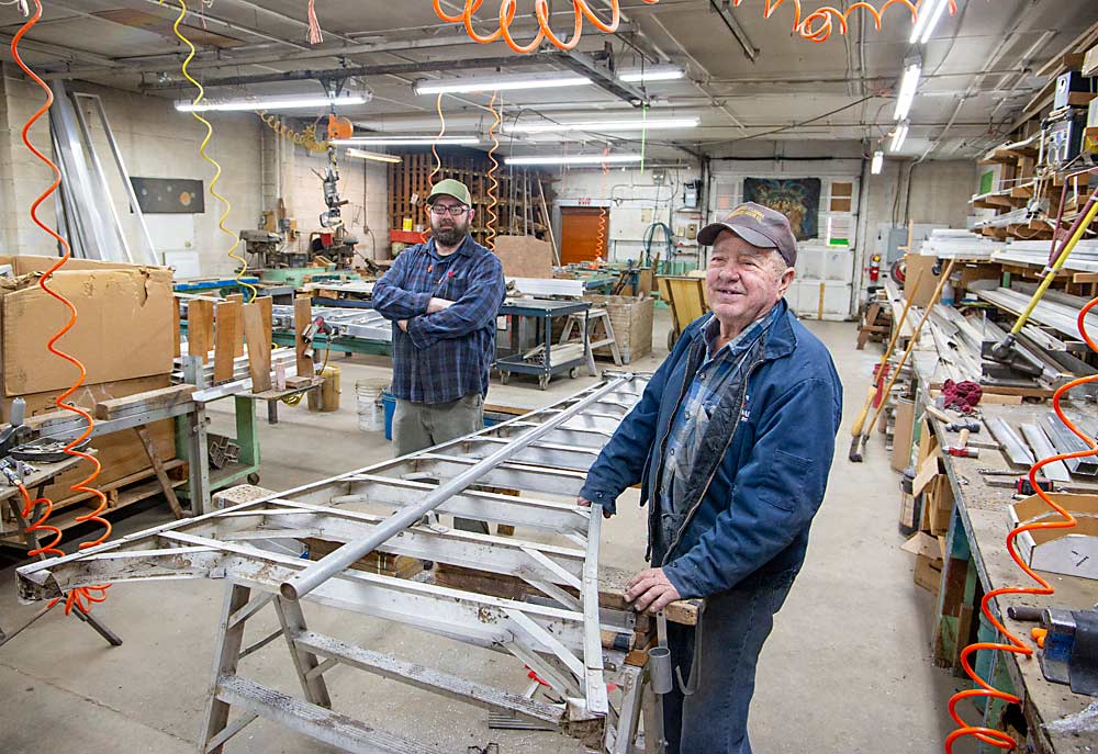Bryce Nieman, right, handed off the Dependable Ladder business to his son, Brad, in 2003. They’re seen here with a repair job, which makes up the bulk of Dependable’s business. (Ross Courtney/Good Fruit Grower)