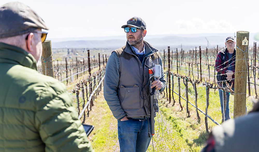 Patrick awn discusses how he uses soil moisture sensors during a sustainability tour that Two Mountain Winery and Dineen Vineyards in Zillah hosted for winemakers and other industry members in April. (Kate Prengaman/Good Fruit Grower)