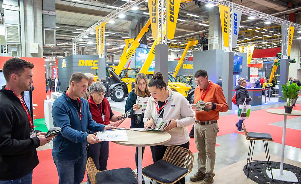 IFTA folks consult maps before attempting to navigate the 20-plus buildings at the EIMA agricultural equipment trade show. (Ross Courtney/Good Fruit Grower)