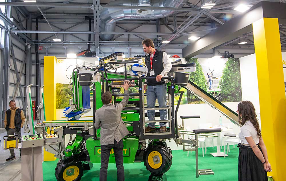 Grower Benjamin Keim of Boyertown, Pennsylvania, tests out the view from atop a Compact orchard platform at the EIMA agricultural equipment trade show in November in Bologna, Italy. While in the country as part of an International Fruit Tree Association tour, Keim perused about a dozen platforms at trade shows. (Ross Courtney/Good Fruit Grower)