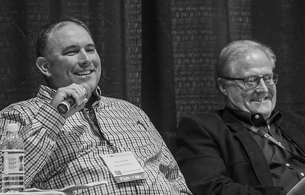 Travis Allan, left, and Don Gibson share a laugh after Gibson (a UW Husky) teases Allan (a WSU Coug) about the 2019 Apple Cup rivalry. (TJ Mullinax/Good Fruit Grower)