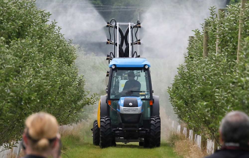 A Hol Spraying System CF airblast sprayer is demonstrated at one of Hedges Apples newer apple blocks in Norfolk County during the 2019 International Fruit Tree Association summer tour in Ontario, Canada, on Monday, July 22. (TJ Mullinax/Good Fruit Grower)
