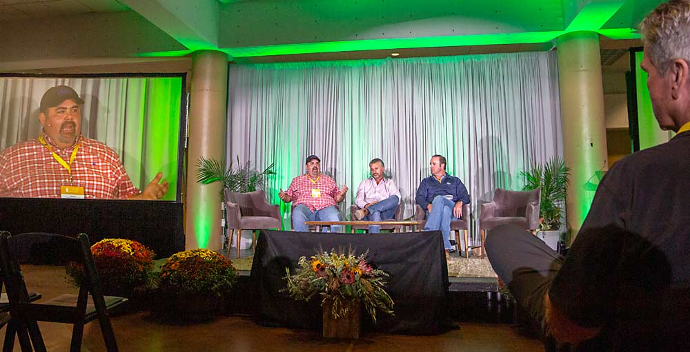 Josh Ruiz of Duda Farm Fresh Foods, left, explains how and when his Salinas vegetable company chooses to invest in automated technology during a grower panel discussion. (Ross Courtney/Good Fruit Grower)