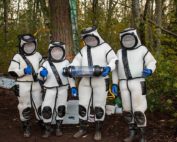 The Washington State Department of Agriculture’s Asian giant hornet eradication team, wearing hornet-proof protective suits, poses with the 85 live hornets they vacuumed from a tree-cavity nest in Northwest Washington on Oct. 24. (Courtesy Washington State Department of Agriculture)