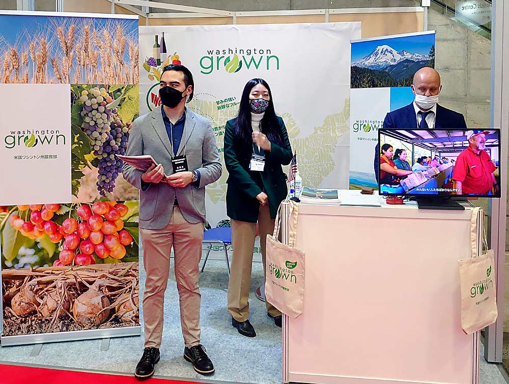 Staffers from the Washington State Department of Agriculture’s international marketing program promote “Washington grown” produce in Japan at a trade show in March. (Courtesy Washington State Department of Agriculture)