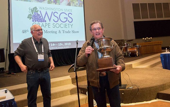 Dennis Pleasant, right, was presented the Grape Society’s Walter Clore award by Bill Riley, chair of the organization, for lifetime contributions to the industry. (Ross Courtney/Good Fruit Grower)