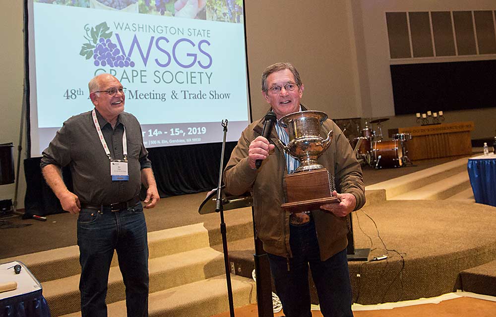 Dennis Pleasant, right, was presented the Grape Society’s Walter Clore award by Bill Riley, chair of the organization, for lifetime contributions to the industry. (Ross Courtney/Good Fruit Grower)