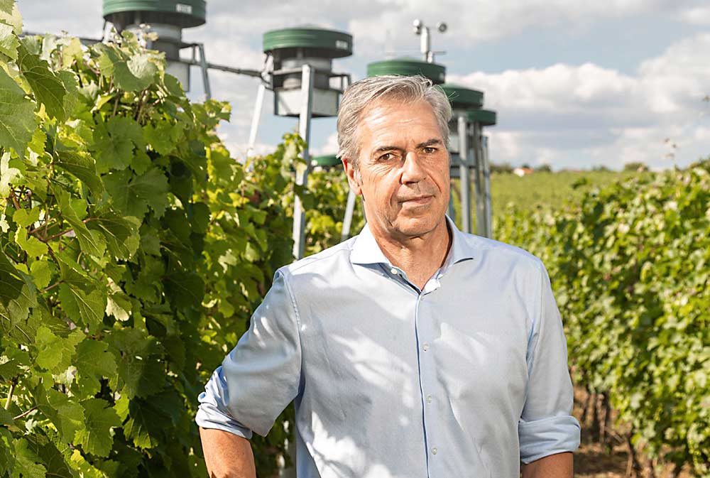 Hans R. Schultz, president of Geisenheim University in Geisenheim, Germany, and a leading expert on viticulture and the impacts of climate change, stands in an experimental vineyard that exposes the plants to 20 percent higher levels of carbon dioxide to help researchers prepare for the potential impacts of climate change on fruit quality in the decades to come. (Courtesy Hans Schultz)