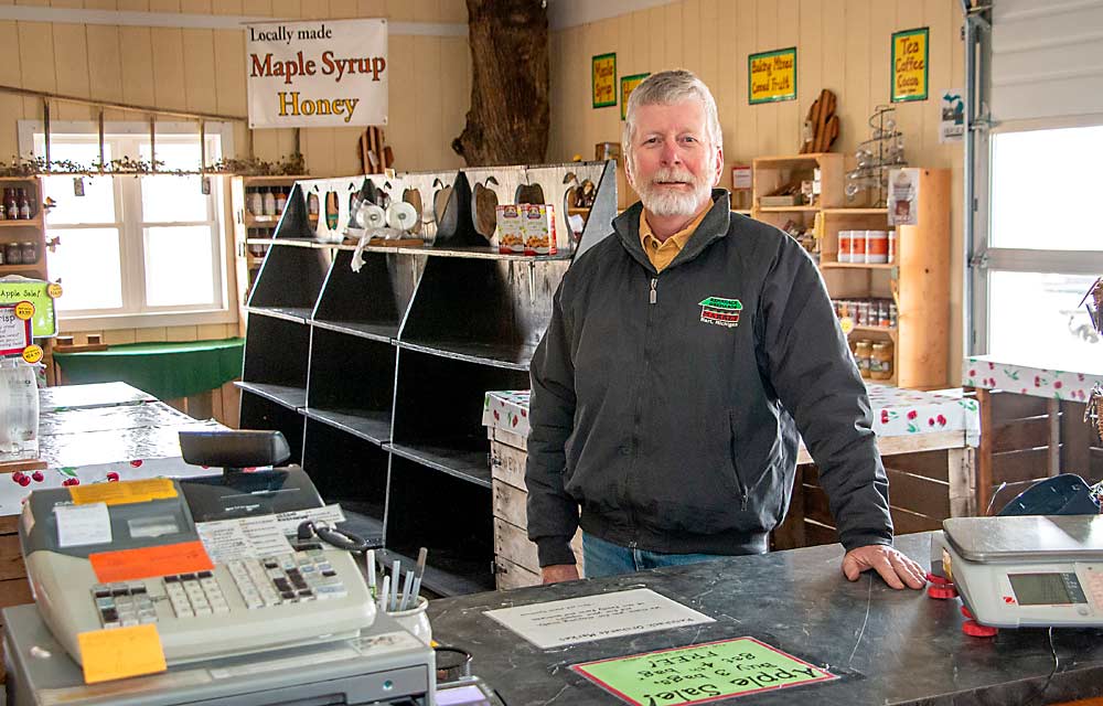 David Rennhack in his farm market in Hart, Michigan, in March. The market has a small but loyal customer base, beefed up by summer tourists. Rennhack sells a variety of fruits and vegetables at the market, including popular apple varieties such as SweeTango, Honeycrisp and EverCrisp. (Matt Milkovich/Good Fruit Grower)