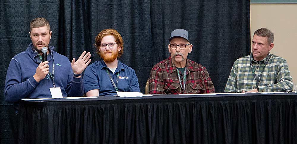 Pear growers, from left, Sam Parker, Chris Strohm, Mel Weythman and Keith Granger discuss integrated pest management in December at the Washington State Tree Fruit Association Annual Meeting in Kennewick. (Ross Courtney/Good Fruit Grower)