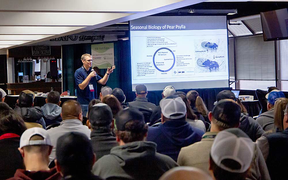 Rodney Cooper, research leader of the U.S. Department of Agriculture laboratory in Wapato, discusses the life cycle of the pear psylla during a pesticide credit class during the annual meeting. (Ross Courtney/Good Fruit Grower)