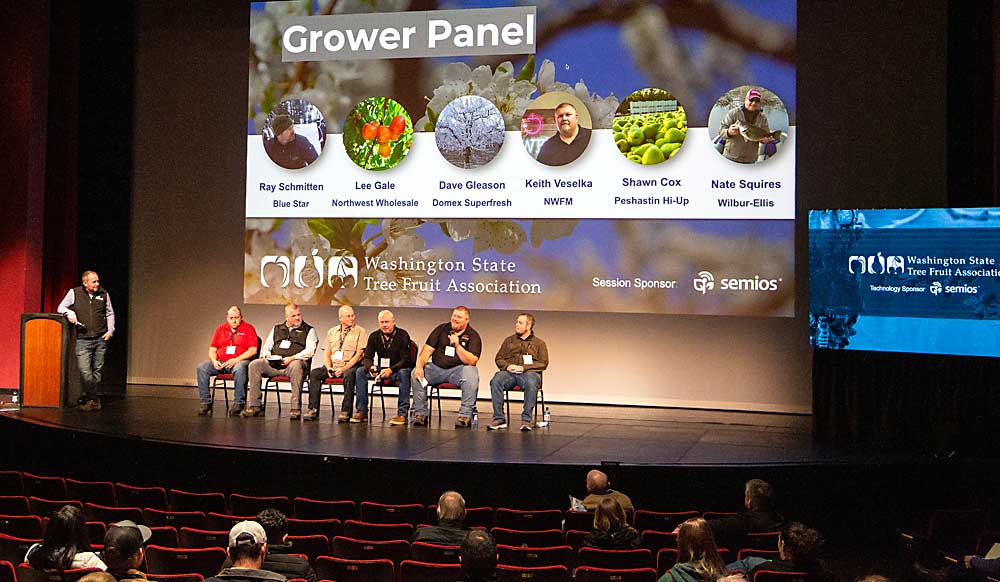 Led by Drew Zabrocki of Semios, at the lectern, growers discuss technology during a panel session at the annual meeting. (Ross Courtney/Good Fruit Grower)
