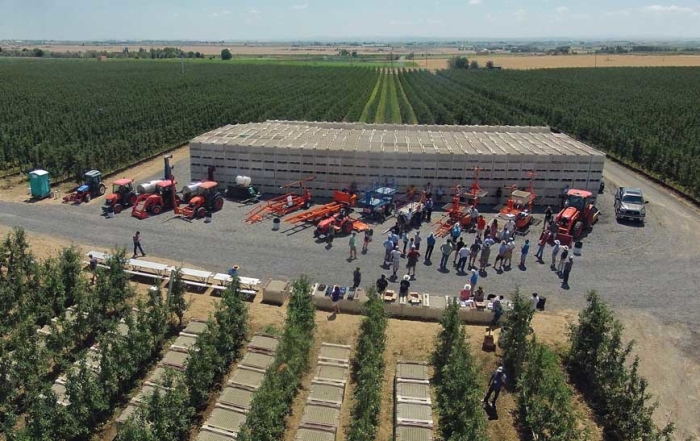 Harvesting, pruning, trimming and bin removal machines like these displayed during an IFTA tour last summer in Washington can help growers reduce labor, improve orchard production and decrease costs. (TJ Mullinax/Good Fruit Grower)