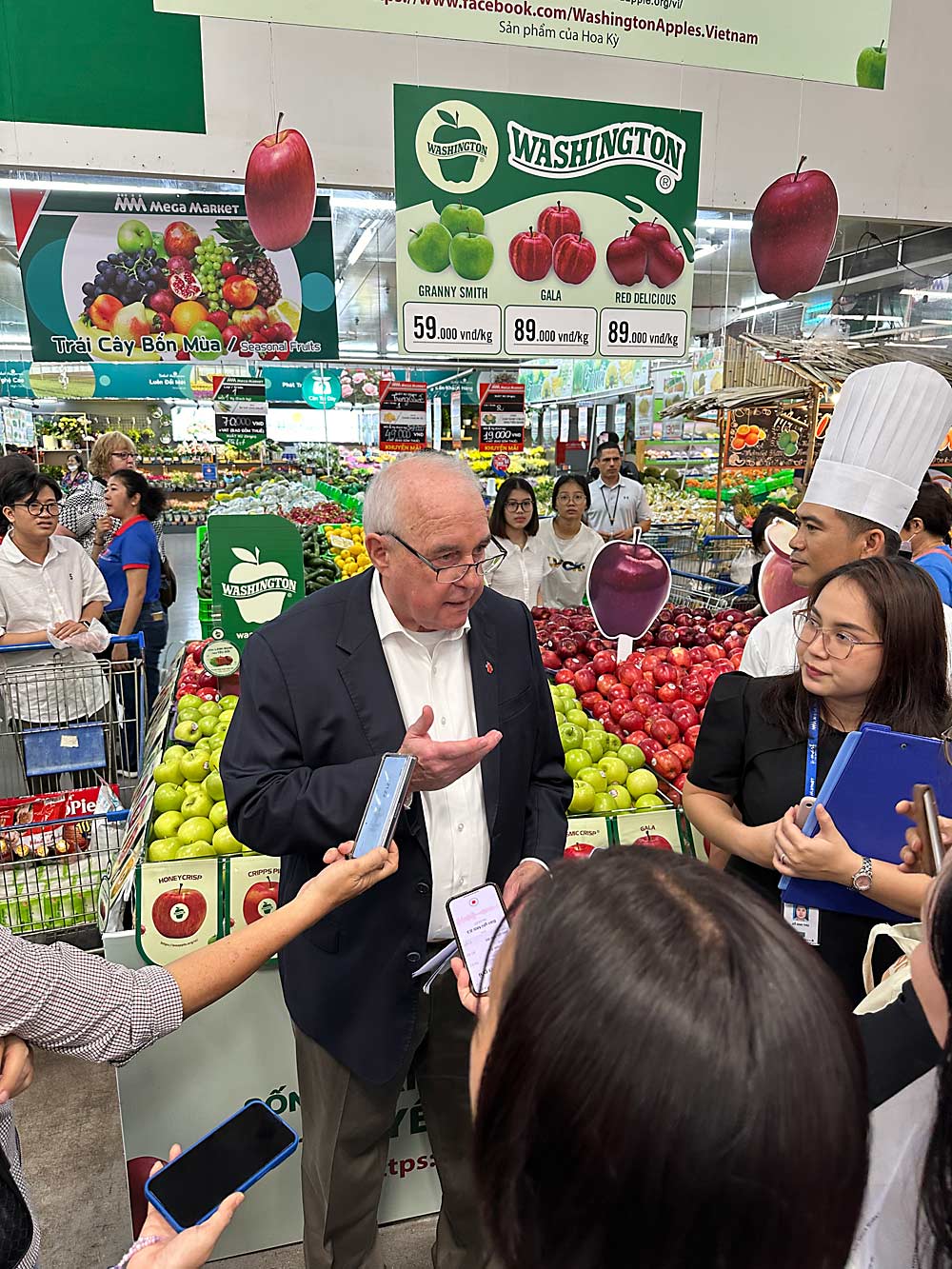 Derek Sandison, director of agriculture for the state of Washington, talks about the important trade relationship between Washington and Vietnam in front of a Washington Apple display at a MM Mega Market in the An Phu district of Vietnam on April 11. (Courtesy Washington State Department of Agriculture)