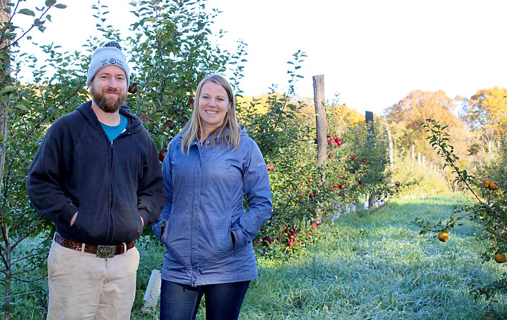 Keepsake Cidery co-owner Nate Watters, at left, collaborated with University of Minnesota extension specialist Annie Klodd to grow European cider apple trees as part of a UMN study at his organic orchard in south-central Minnesota. (Courtesy University of Minnesota Extension)