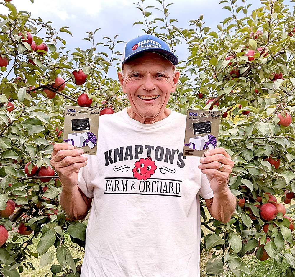 Good Fruit Grower survey contest winner Mel Knapton with his prize in his orchard near Rockford, Minnesota, in October. (Courtesy Mel Knapton)