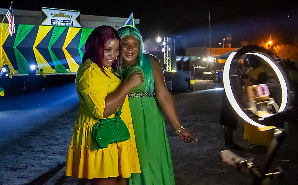 From left, friends Wenaye Holness and Tomoya Morgan pose for a 360-degree camera on the dance floor. (Ross Courtney/Good Fruit Grower)