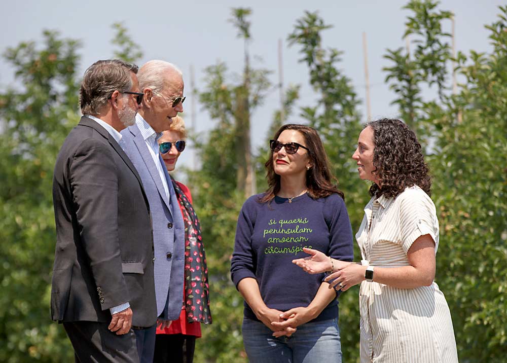 Juliette King McAvoy, right, talks with President Joe Biden at her family’s orchard on July 3. Biden is flanked by Michigan Sens. Gary Peters and Debbie Stabenow. Michigan Gov. Gretchen Whitmer stands in the center. (Courtesy Beth Price)