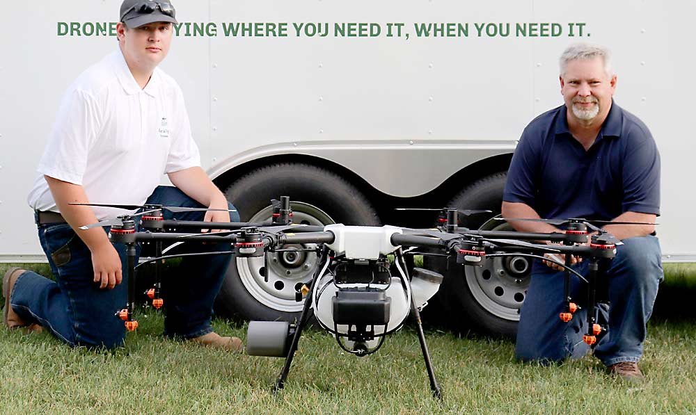 Kirk Babcock, right, and his son, Jacob, run Aerial Ag Technologies, a contractor for Rantizo, an Iowa-based spray-drone company that sells equipment and trains contractors such as the Babcocks. As of January, Rantizo was the only company certified to spray crops with drones in Michigan. Seen here is the DJI Agras MG-1P drone, which has a 2.7-gallon tank and a 10-minute flight time. (Courtesy Aerial Ag Technologies)