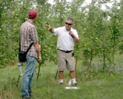 Mario Miranda Sazo, right, and Jaume Lordan, both from Cornell University, discuss the need for irrigation in high-density apple systems in an organic GoldRush block at Bittner-Singer Farm in Appleton, New York. (Kate Prengaman/Good Fruit Grower)