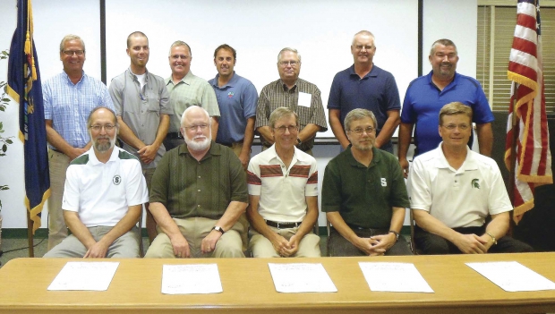 Members of the board of the new Michigan Tree Fruit Commission met with Michigan State University officials to sign a letter of agreement, pledging mutual financial support. Front row, from left, are Doug Buhler, head of AgBioReseach; Fred Poston, dean of the College of Agriculture and Natural Resources; cherry grower Jim Nugent, chair of the board; Ray Hammerschmidt, MSU Extension; and Chuck Reid, head of the land management office at MSU. In the back row, from left, are growers Jim Engelsma, Patrick Goodfellow, Mike VanAgtmael, Mark Miezio, Randy Willmeng, Fred Koenigshof, and Steve Thome. Grower Rick Sayler missed the photo. (Richard Lehnert/Good Fruit Grower)