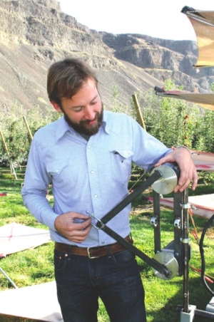 Mark De Kleine holds a test device to mechanically harvest apples for the fresh market. by Geraldine Warner/Good Fruit Grower