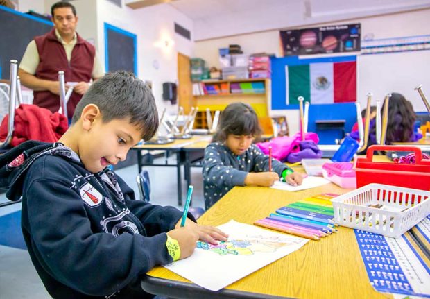 First-grader Santiago Ramos, whose parents work seasonally in the cherry orchards, colors a map of Mexico in late June during the Migrant Education Program at Chenowith Elementary School in The Dalles, Oregon. Several Columbia River Gorge fruit growers contributed money to help continue the program, where many of their seasonal employees’ children go during the day. (Ross Courtney/Good Fruit Grower)