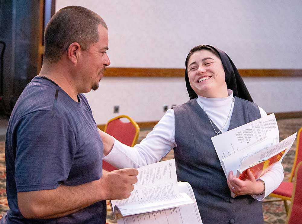 Sister Blanca Jimenez and worker Jesús Romero rehearse a few praise songs before the procession. (Ross Courtney/Good Fruit Grower)