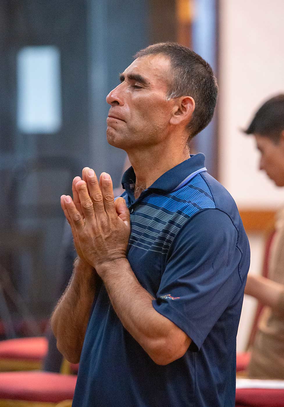 Francisco Garcia of Oaxaca, Mexico, prays for his health, the health of his co-workers and the health of his family at home during a worship service in Yakima. (Ross Courtney/Good Fruit Grower)