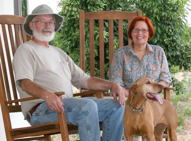 Mike and Nori Naylor, and Henny the farm dog, relax on the porch of their farm stay. (Melissa Hansen/Good Fruit Grower)