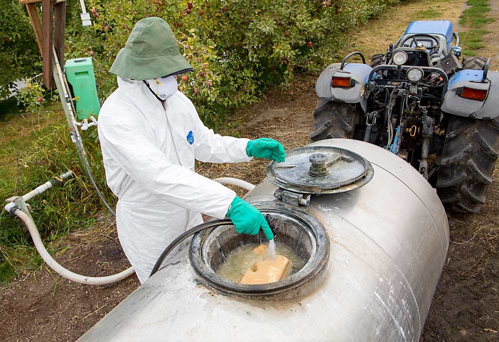 Camilo Valle mixes nematodes that act as a biocontrol for codling moth into a spray tank for deployment in September at Wahluke Heights Orchard near Mattawa, Washington. (Ross Courtney/Good Fruit Grower)
