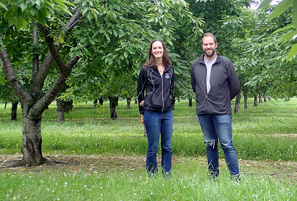 Laura Rigan, left, Grand Traverse Regional Land Conservancy (GTRLC) farmland protection manager, and Isaiah Wunsch on a 40-acre orchard he and his family added to their farm holdings north of Traverse City, Michigan, in July 2021. Wunsch was able to purchase the property despite skyrocketing land prices, thanks in part to the help of the GTRLC.Rigan’s family owns a vineyard nearby. (Leslie Mertz/for Good Fruit Grower)