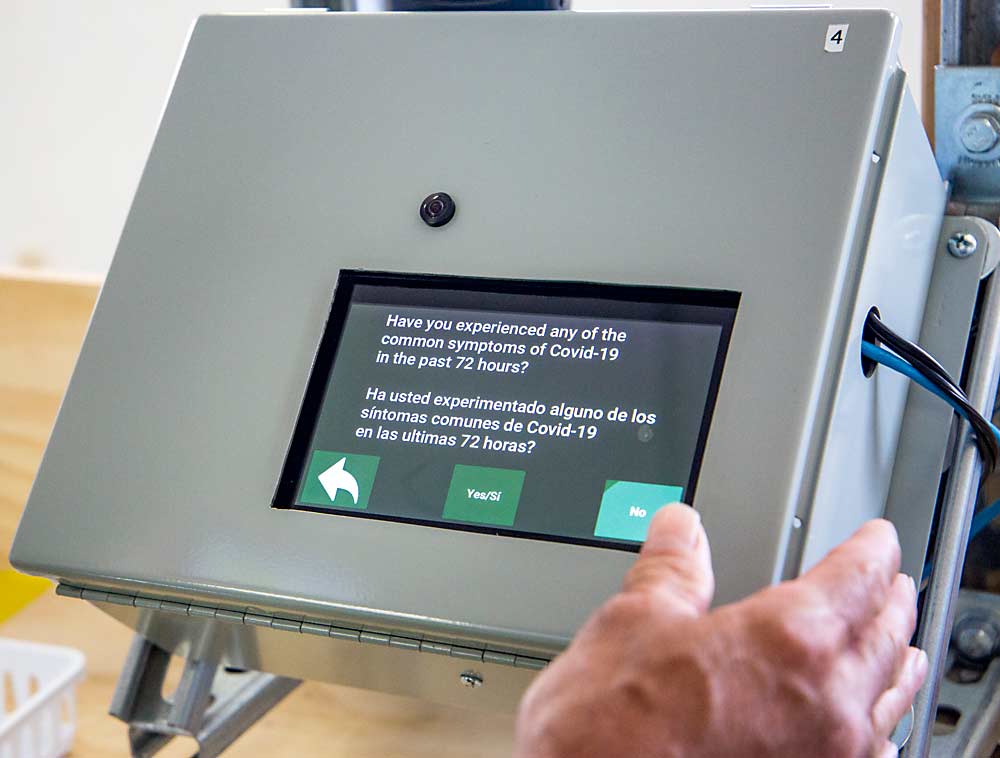 Questions about coronavirus symptoms greet employees as they clock in at Matson Fruit. If the worker answers yes, the computer system automatically notifies supervisors and managers. (Ross Courtney/Good Fruit Grower)