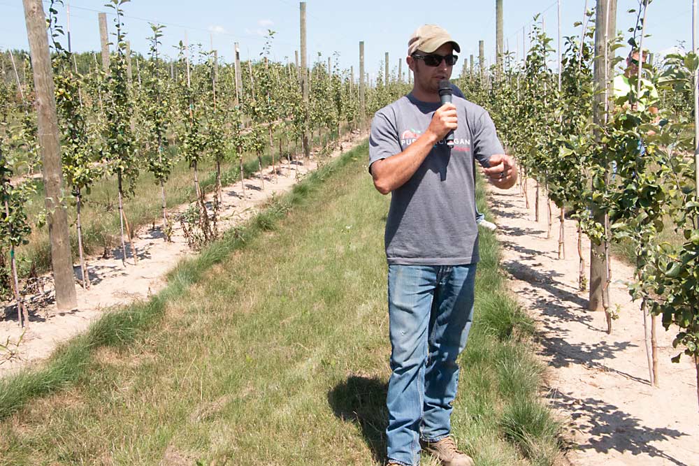 Randy Kober describes his experiences with a plant-in-place block of Honeycrisp during RidgeFest 2020, the annual summer fruit tour organized by Michigan Pomesters on Aug. 6 in Kent City, Michigan. (Matt Milkovich/Good Fruit Grower)